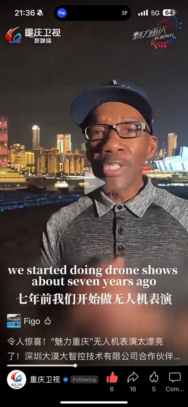Pinnacle founder John Eric Henry speaking on Chongqing Satellite TV with Chongqing’s illuminated skyline behind him.
